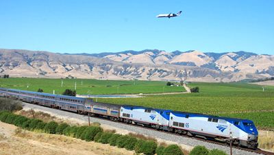 Amtrak train with airplane overhead