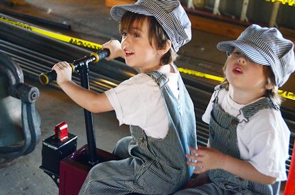 two kids in railroad garb