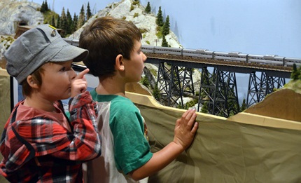 two boys viewing a model railroad