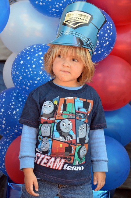 young boy with Amtrak hat