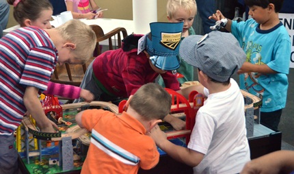 kids at a train play table