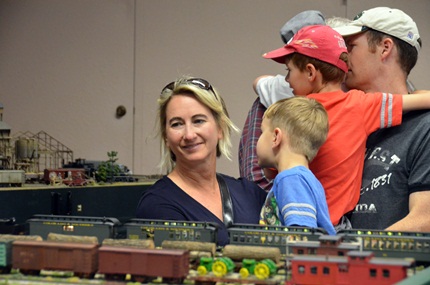 people enjoying model trains