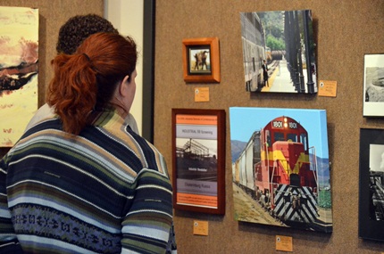 adults viewing train photos