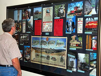 man looking at railroad photos